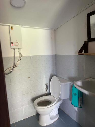 a bathroom with a toilet and a sink at Benny monkey house in Rayong