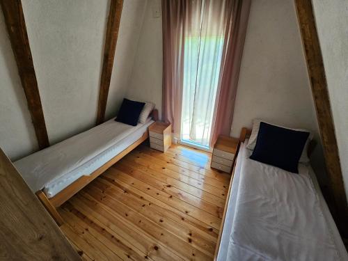 a small room with two beds and a window at Koliba BUKOVICA in Šavnik