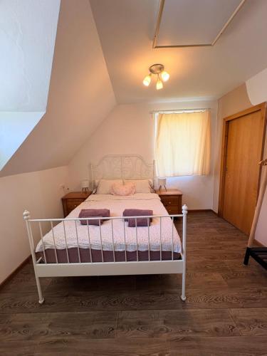 a bedroom with a white bed in a attic at Apartma Arja in Spodnje Gorje