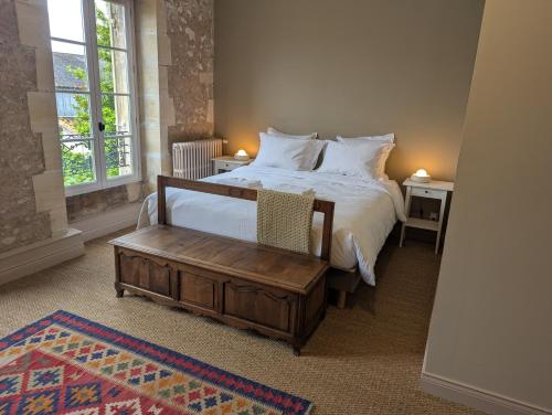a bedroom with a bed with white sheets and pillows at Domaine de Chaunac in Chaunac