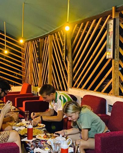 a group of people sitting at a table eating food at Sea secret in Arugam Bay