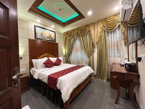 a hotel room with a bed and a desk and a bed sidx sidx at Palmscape Boutique Hotel in Hulhumale