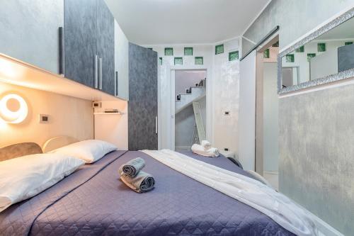 a bedroom with a large bed with towels on it at Prestige House in Nulvi