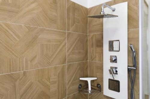 a bathroom with a wooden tile wall and a shower at Villa Giusy in Verdellino
