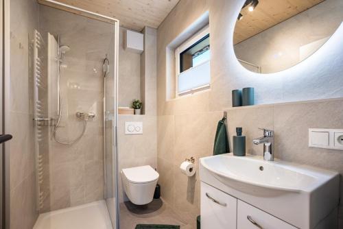 a bathroom with a shower and a toilet and a sink at Ferienhaus Auerberg Sweet in Stötten am Auerberg