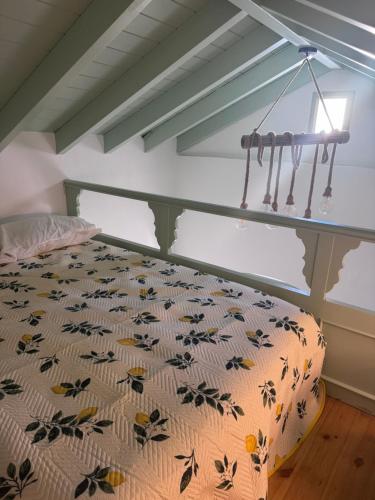 a bedroom with a bed with a comforter at La Maisonette de Symi in Symi