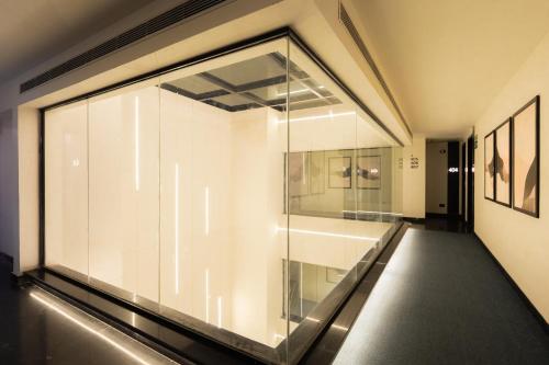 a large glass window in a room with a sink at Hotel Limon Sector 45 Gurgaon in Gurgaon