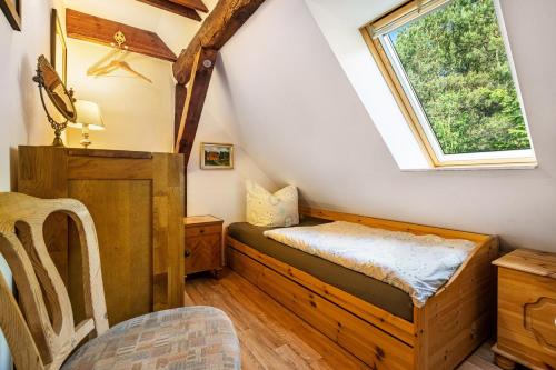 a small room with a bed and a window at Landsitz Blankensee in Blankensee