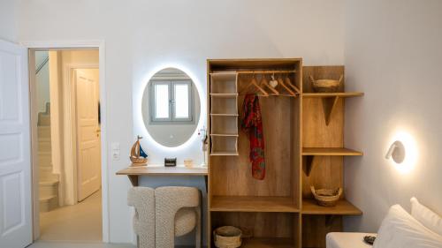 a room with a dressing table and a mirror at Cavo Blue Villas in Elia Beach