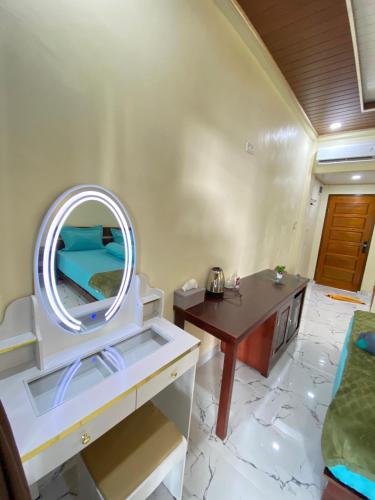 a bathroom with a sink and a mirror at Pele's Place Coral Reef Bungalows & Café Maman in Sabang