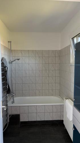 a bathroom with a bath tub in a room at Haus am Waldrand in Göttschach