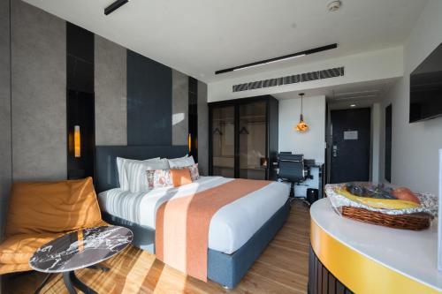 a hotel room with a bed and a couch at Hotel Limon Sector 45 Gurgaon in Gurgaon
