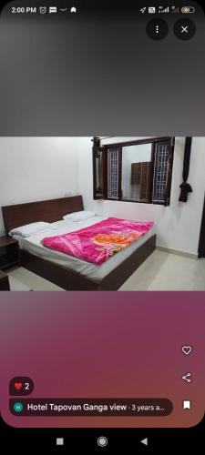 a bedroom with a bed with a pink blanket at Tapovan ganga view in Uttarkāshi
