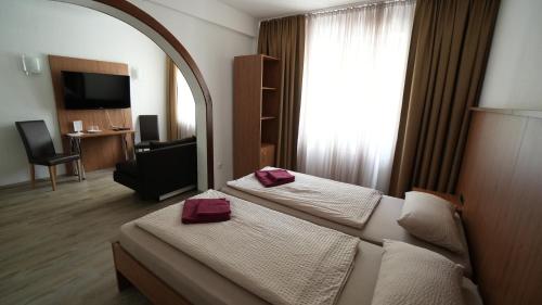 a hotel room with two beds and a mirror at Berl Inn in Berlin