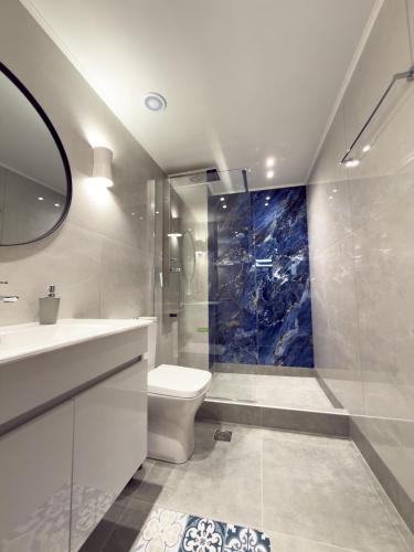 a bathroom with a toilet and a sink and a shower at DNS Elements Apartments 2 in Nea Karvali