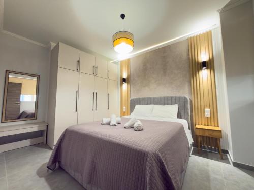 a bedroom with a bed with two towels on it at DNS Elements Apartments 2 in Nea Karvali