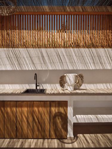 a kitchen with a sink and a counter at Theros Luxury Suites in Agios Nikolaos