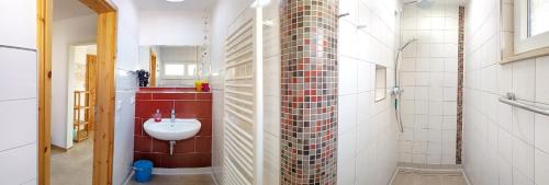 a bathroom with a sink in a brick wall at Ferienhaus Krawulski in Hohnstein
