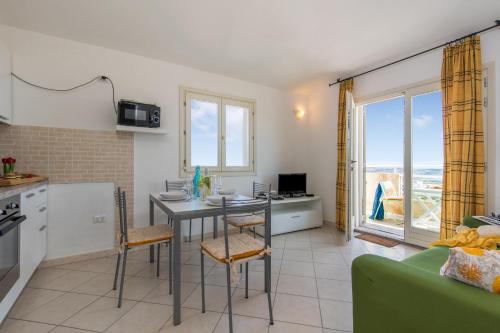 a kitchen and living room with a table and chairs at Elicriso - Happy Rentals in San Pasquale