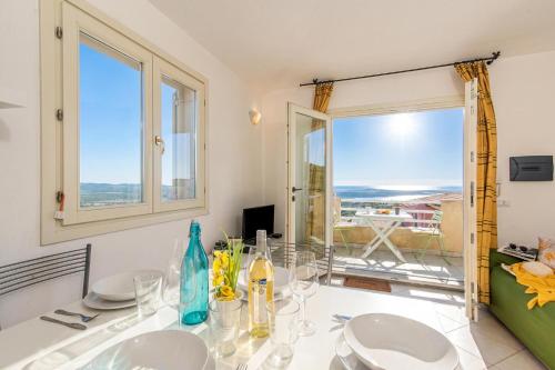 a dining room with a table and two windows at Elicriso - Happy Rentals in San Pasquale