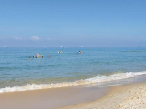 a group of people in the water at the beach at studio by the sea in Ashdod