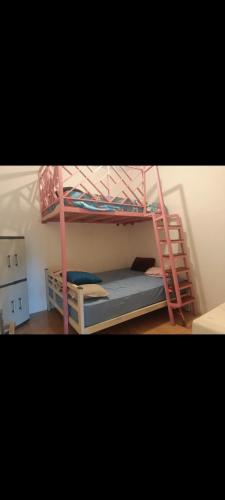 a bedroom with a bunk bed with a ladder at Gandasari homestay banyuwangi in Banyuwangi