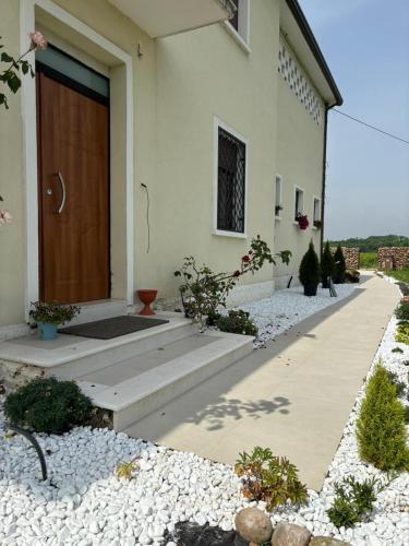 a house with a wooden door on the side of it at Vigne Del Garda in Villafranca di Verona