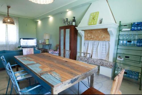 a dining room with a wooden table and chairs at Vigne Del Garda in Villafranca di Verona
