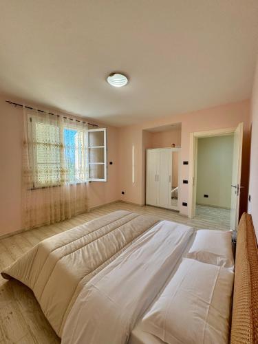 a large bed in a large room with a window at Luxury Villa Cenaia in Cenaia Vecchia