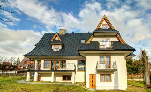 a house with a gambrel roof at Willa Świderka in Kościelisko