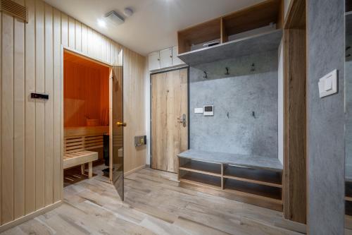 a bathroom with a bath tub and a walk in shower at Visit sauna Klinovec in Loučná pod Klínovcem