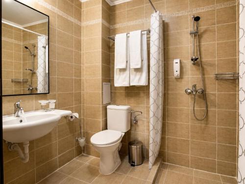 a bathroom with a toilet and a sink and a shower at Effect Boutique Villa Azzura - Adults Only SELF CHECK-IN in Nesebar
