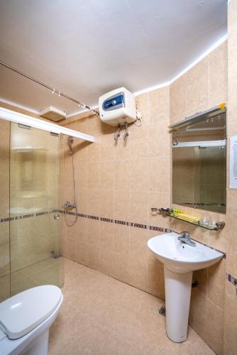 a bathroom with a toilet and a sink and a shower at Hung Long Harbour Hotel in Cat Ba