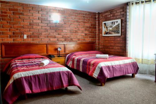 Postel nebo postele na pokoji v ubytování Hotel Esperanza