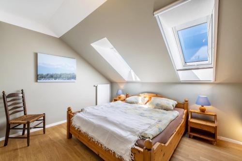 a bedroom with a bed and two windows at Hof am Ammersee in Pähl