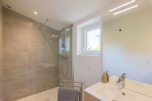 a bathroom with a sink and a shower at Charmante Maison Vallon pont d'Arc in Vallon-Pont-dʼArc