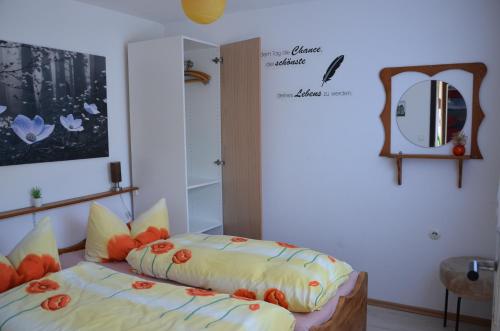 a bedroom with two beds and a mirror at Ferieneinrichtungen Haus am Stein bei B in Königstein an der Elbe
