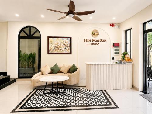 a living room with a couch and a ceiling fan at Maison Hin in Hoi An