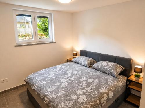 a bedroom with a bed with two pillows on it at Apartment Beli in Radovljica