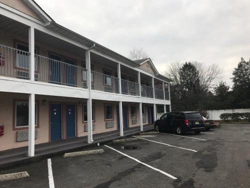 a car parked in a parking lot in front of a hotel at Mayfair Motel in Cross Keys