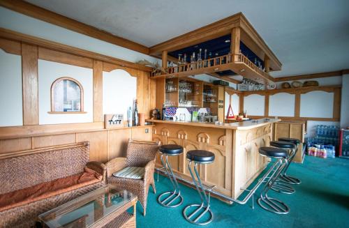 a kitchen with a bar with stools in it at Babsi Appartments - leben am Land in Wels