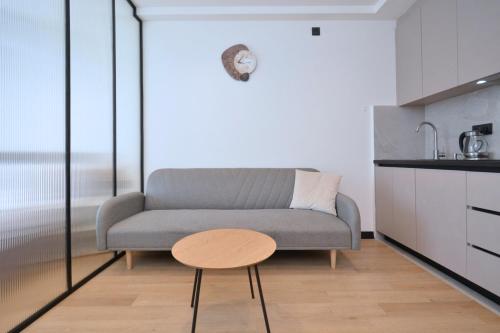 a living room with a couch and a table at Chic city apartment I By Domel Yerevan in Yerevan