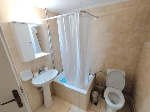 a bathroom with a shower and a toilet and a sink at Cucuvaya Rithy in Áyios Andónios