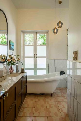 a large bathroom with a tub and two sinks at Villa Kefi in Assagao