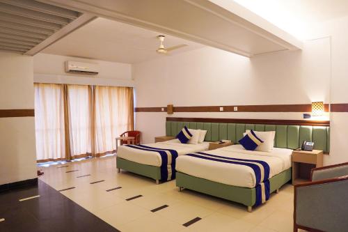 a hotel room with two beds in a room at The Sea Princess Hotel in Cox's Bazar