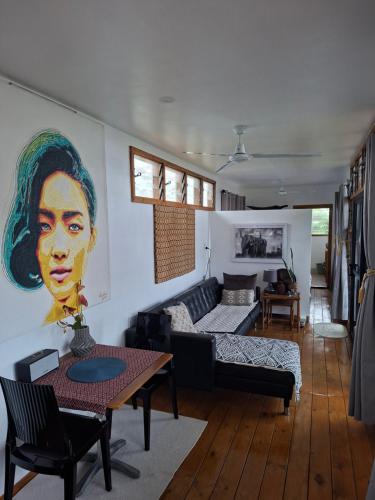 a living room with a couch and a table at Luna Studio in Apia