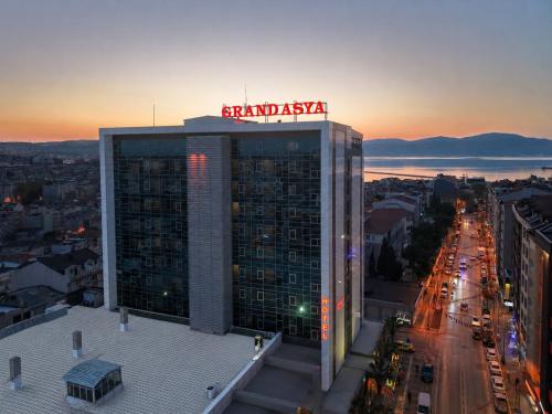 a tall building with a sign on top of it at Grand Asya Hotel in Bandırma