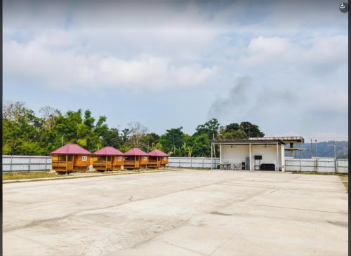 a group of buildings with red roofs in a parking lot at Villa Cedes in Lasam