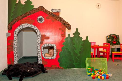 a child in a play room with a gingerbread house at Haus Anemone in Serfaus