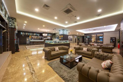a large living room with couches and a table at Grand Asya Hotel in Bandırma